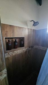 a shower in a bathroom with jars on the wall at Harvey's Mizpahcot Oasis - Cruise Port, Us Embassy and Vacation in Bridgetown +6 photos