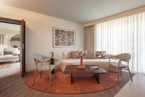 a living room with a couch and chairs and a table at Kimpton Atlantico Algarve by IHG in Albufeira