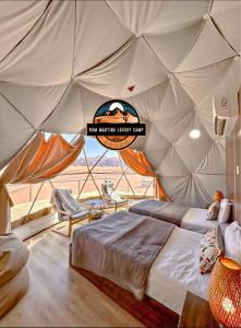 a room with a bed in a tent at RUM MARTINA lUXURY CAMP in Wadi Rum