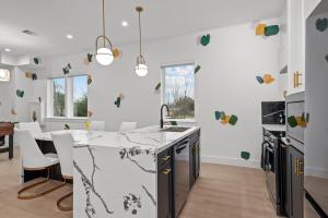 a kitchen with white walls and a marble counter top at Elegant home with Houston cityscape and rooftop in Houston