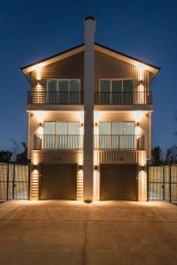 a house with lights on the front of it at Elegant home with Houston cityscape and rooftop in Houston