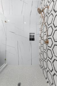 a bathroom with a shower with a glass door at Elegant home with Houston cityscape and rooftop in Houston +53 photos