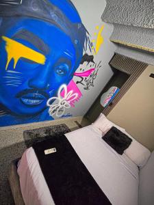 Postel nebo postele na pokoji v ubytování Urban Hostal Barrancabermeja