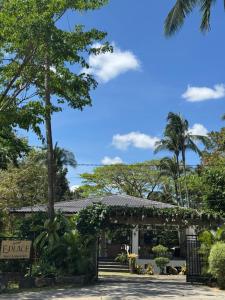 a building with a pergola and palm trees at E-Place Resort in Magallanes