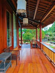 a porch of a house with benches on it at Moc Homestay & Villa in Cư Chinh