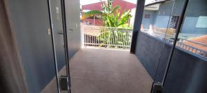 a corridor of a building with a view of a balcony at Casa grande ideal para grupo e empresas in Joinville