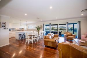 a kitchen and living room with a table and chairs at Ardington - 4-Bed Pet-Friendly with Pool in Moore Creek