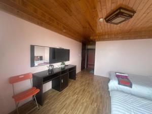 a bedroom with a bed and a desk with a tv at Nhà Nghỉ Đức Anh in Sa Pa