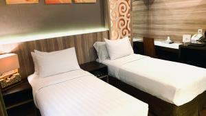 Postel nebo postele na pokoji v ubytování Oxville Hotel