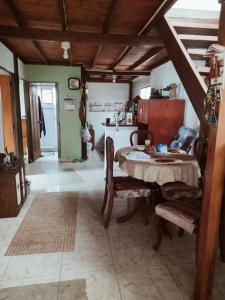 a kitchen with a table and chairs in a room at Kynza Turismo Rural in Ubaque