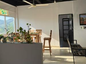 a living room with a table and chairs at Casa Encanto in Taganga