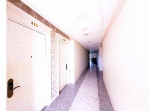 a hallway with a white door in a building at Phoenix Hotel Vung Tau in Vung Tau