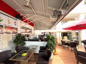 a restaurant with tables and chairs and a counter at Phoenix Hotel Vung Tau in Vung Tau