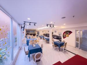 a dining room with blue tables and chairs at Phoenix Hotel Vung Tau in Vung Tau