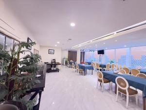 a dining room with blue tables and chairs at Phoenix Hotel Vung Tau in Vung Tau