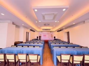 a large room with blue tables and chairs at Phoenix Hotel Vung Tau in Vung Tau