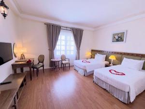 Postel nebo postele na pokoji v ubytování Phoenix Hotel Vung Tau