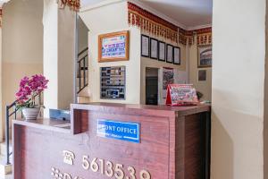 a cashier counter in a restaurant with flowers at Hotel Maleo - 6 Hour Stay in Palembang