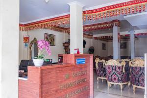 a restaurant with a table and chairs in a room at Hotel Maleo - 6 Hour Stay in Palembang