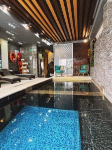 a swimming pool in a building with two chairs at Mantra Hotel Boutique in Santa Marta +174 photos