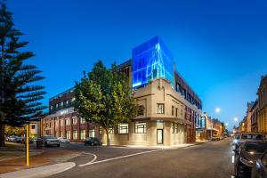 a building with a glass facade on a city street at Quest Fremantle in Fremantle
