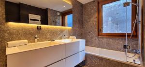 a bathroom with a sink and a mirror at Les Flambeaux - Apartment with Panoramic View - Alp'in C in Châtel +24 photos
