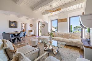 a living room with a couch and a table at Villa Flore - Panoramic Sea View by Halldis in Vallauris