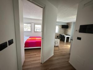 a view of a bedroom with a bed and a window at Penelope Home by Casa e Lode in Passo del Tonale