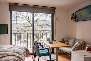 a living room with a table and a couch at NADA Terrace in Higashi-nada-eki