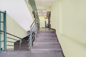 a staircase in a building with a stair railing at Hotel O East Fort in Trivandrum