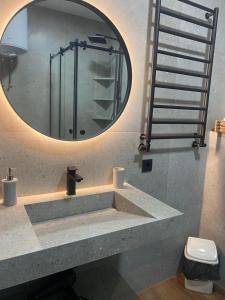 a bathroom with a sink and a mirror at Style Apartament-studio, ЖК КиївСкай in Lutsk +9 photos
