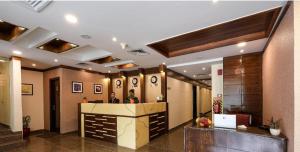 a lobby with a reception desk in a building at SK Premium Park GGN in Gurgaon