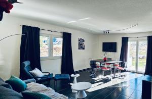a living room with a couch and a table and chairs at Soulmates Resorts - Feldberg in Feldberg