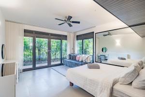 a bedroom with two beds and a couch at 3BR Casa Oasis - Beachfront Home in Laguna & Layan Chom Tawan and Maan Tawan Residences in Phuket Town +33 photos