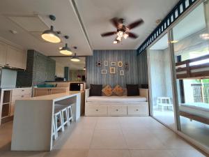 a kitchen with a ceiling fan and a couch at Marrakesh Residence HuaHin BunkBed Family Room in Hua Hin