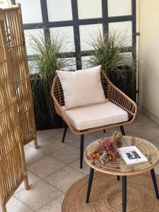 a wicker chair and a table on a balcony at DImORA sALAmAC in Monteroni di Lecce