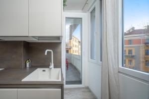 a kitchen with a sink and an open window at Flower Apartment - Affitti Brevi Italia in Trieste