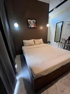 a small bedroom with a bed with white sheets at Room in a Private Villa in San Jose de Buenavista +3 photos