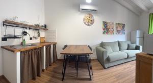 a kitchen and living room with a couch and a table at A'nicaredda (la piccolina) in Castellammare del Golfo