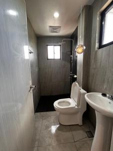 a bathroom with a toilet and a sink at Room in a Private Villa in San Jose de Buenavista