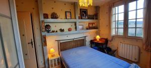a bedroom with a bed in a room with windows at Maison avec piscine et jardin d'arbres fruitiers in Cours-de-Pile