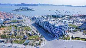 an aerial view of a large building next to the water at Homestay Newlife Tower Vipp in Ha Long