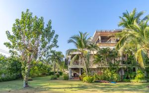 a resort with palm trees in front of it at 3BR Casa Oasis - Beachfront Home in Laguna & Layan Chom Tawan and Maan Tawan Residences in Phuket Town
