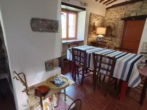 a kitchen and dining room with a table and chairs at Pilgrim Rooms in Gubbio
