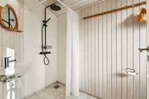 a bathroom with a shower and a sink at Hyggeligt Sommerhus Med Havudsigt in Fåborg +21 photos