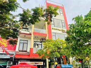 a tall red and white building on a city street at Sontra Sea Hotel in Danang