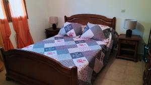 a bedroom with a bed with a quilt on it at Maison cooconing in Sumène
