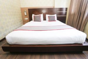 a bedroom with a large bed with white sheets and pillows at Hotel Pesona Cikarang 6 Hour Stay in Kedungg +16 photos