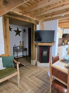 a living room with a fireplace and a television at La Casa De Los NAVARONES in Vilviestre de los Nabos