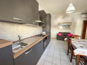 a kitchen with a sink and a table in a room at La Conchiglia - Pineto Vacanza in Pineto
